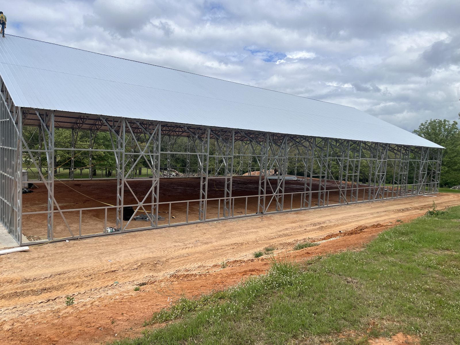 Completed arena roof over open steel framing, long side elevation