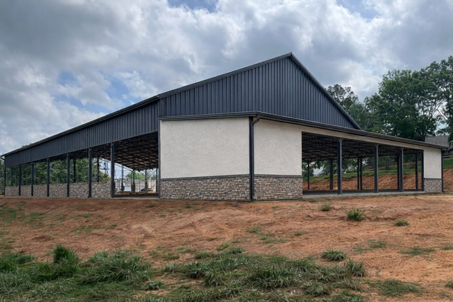 Finished arena with stucco gable end and stone wainscot