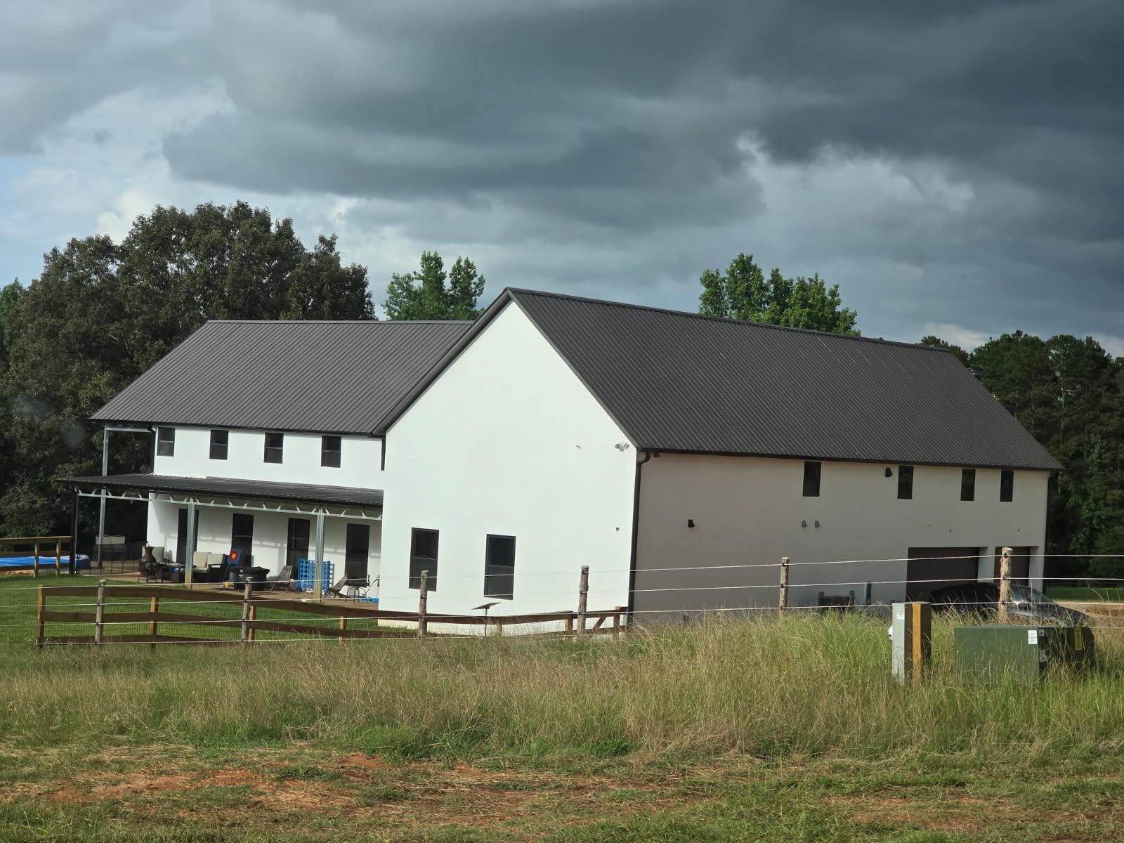 Two-story TubeCrete home with stucco walls and standing seam metal roof